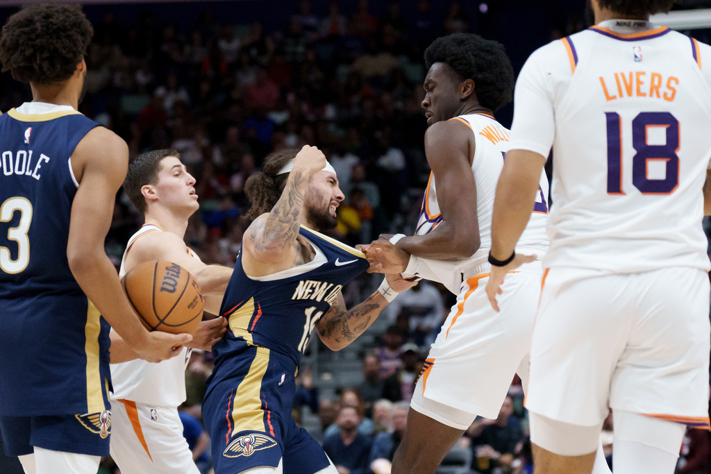 New Orleans Pelicans guard Jose Alvarado, center left, and Phoenix Suns center Mark Williams, center right, get into a scrum during the third quarter before both were ejected during an NBA basketball game in New Orleans, Saturday, Dec. 27, 2025. (AP Photo/Matthew Hinton)
