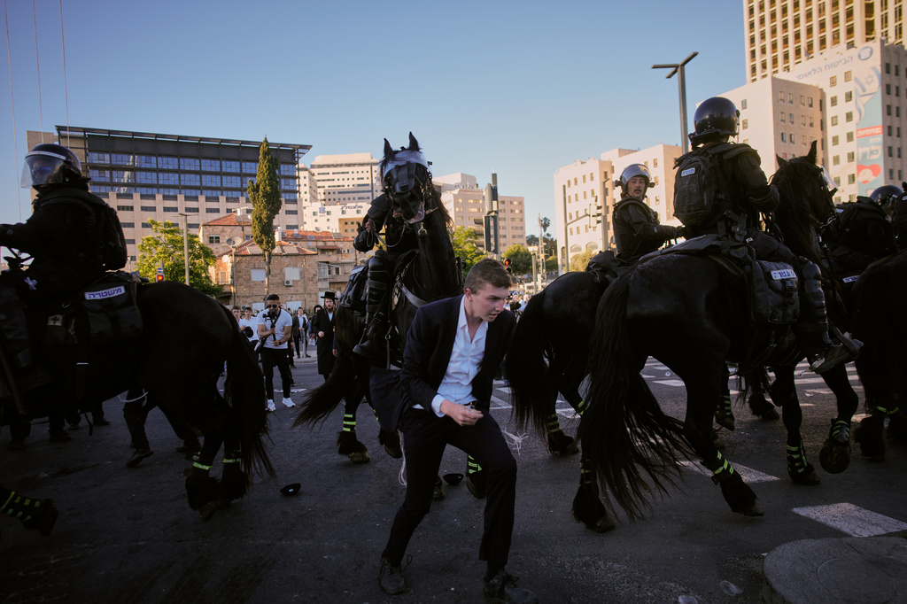 Israeli mounted police disperse Ultra-Orthodox Jews blocking a road during a protest against army draft in Jerusalem, Monday, June 1, 2026. (AP Photo/Ohad Zwigenberg)