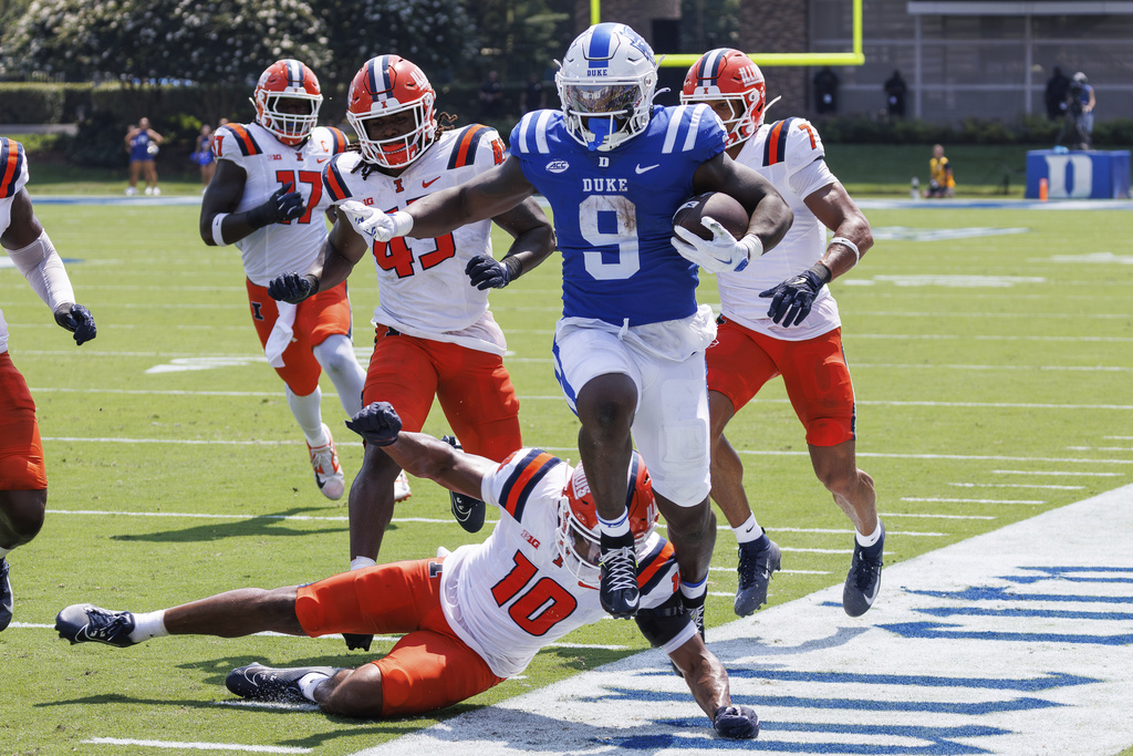 Duke's Jaquez Moore (9) carries the ball ahead of Illinois' Miles Scott (10) during the first half of an NCAA college football game in Durham, N.C., Saturday, Sep. 6, 2025. (AP Photo/Ben McKeown)