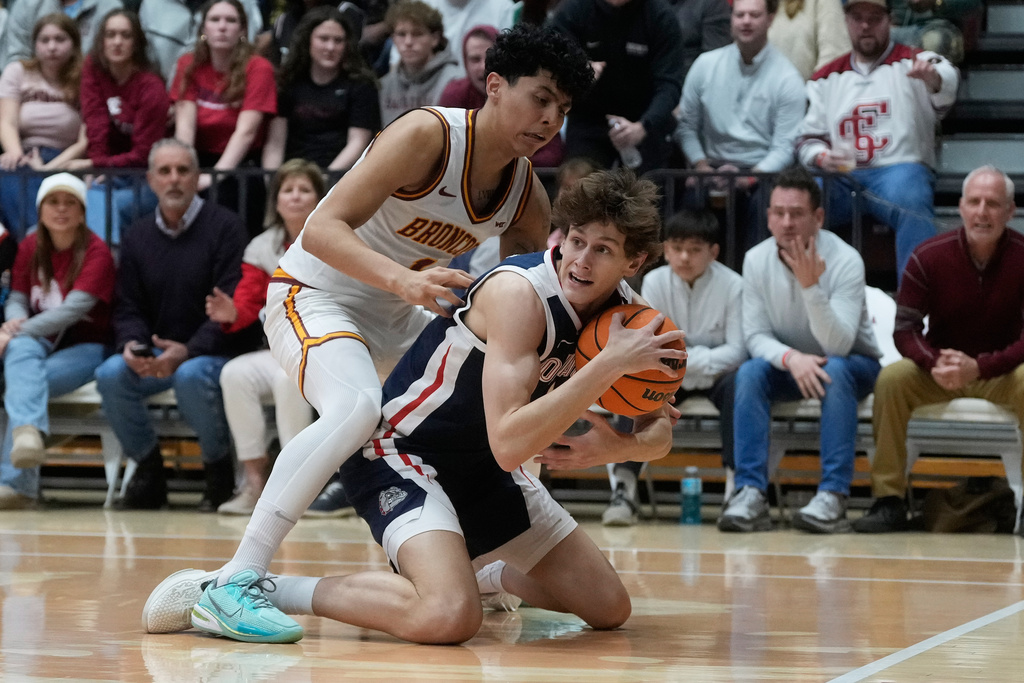 Gonzaga guard Davis Fogle, bottom, holds onto the ball under Santa Clara guard Christian Hammond during the first half of an NCAA college basketball game in Santa Clara, Calif., Saturday, Feb. 14, 2026. (AP Photo/Jeff Chiu)