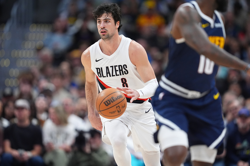 Portland Trail Blazers forward Deni Avdija collects a loose ball in the first half of an NBA basketball game against the Denver Nuggets Monday, April 6, 2026, in Denver. (AP Photo/David Zalubowski)
