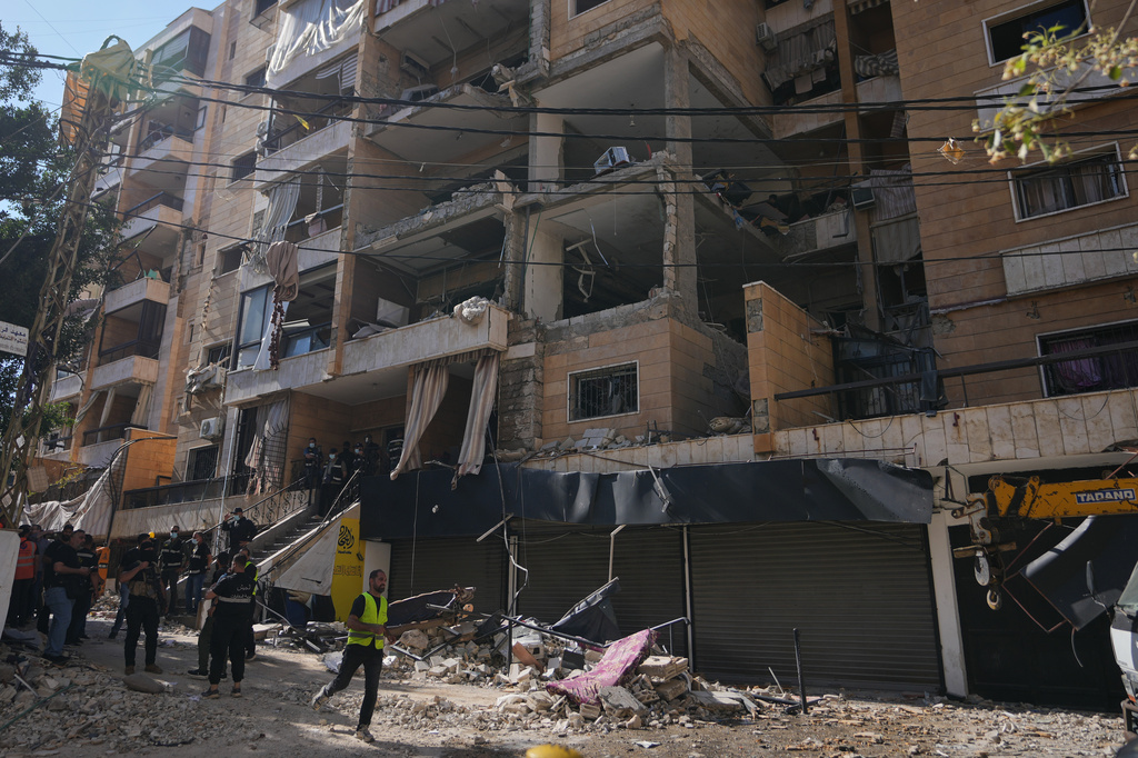 Lebanese security officers gather at the site where an Israeli airstrike hit a building in Dahiyeh, Beirut's southern suburb, Lebanon, Sunday, June 7, 2026. (AP Photo/Hassan Ammar)