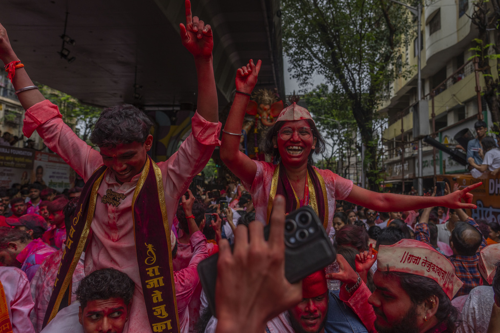 Devotees dance as an idol of the elephant-headed Hindu god Ganesha is taken for immersion on the final day of the ten-day-long Ganesh Chaturthi festival in Mumbai, India, Saturday, Sept. 6, 2025. (AP Photo/Rafiq Maqbool)