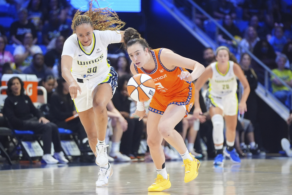 Connecticut Sun guard Marina Mabrey (3) steals the ball from Dallas Wings guard Haley Jones (30) during the first half of a WNBA basketball game in Arlington, Texas, Wednesday, Aug. 27, 2025. (AP Photo/LM Otero)