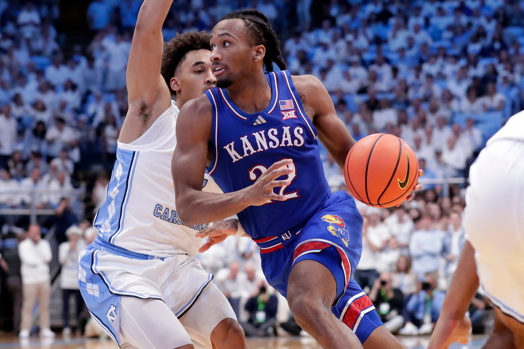 Kansas guard Darryn Peterson, right, drives against North Carolina guard Seth Trimble, left, during the second half of an NCAA college basketball game Friday, Nov. 7, 2025, in Chapel Hill, N.C. (AP Photo/Chris Seward)