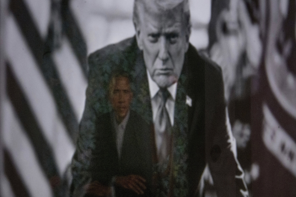 A reflection of the portrait of former President Barack Obama is seen in a photograph of President Donald Trump on display at the Smithsonian's National Portrait Gallery's "American Presidents" exhibit on Sunday, Jan. 11, 2026 in Washington. (AP Photo/Rod Lamkey, Jr.)