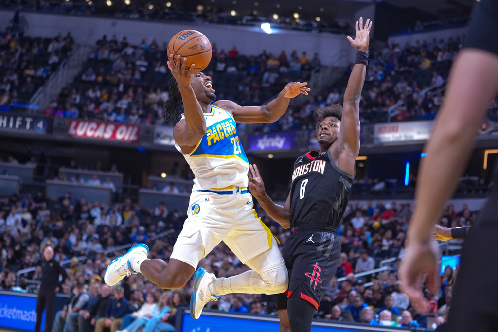 Indiana Pacers guard/forward Aaron Nesmith (23) shoots over Houston Rockets forward Jae'sean Tate (8) during the first half of an NBA basketball game in Indianapolis, Monday, Feb. 2, 2026. (AP Photo/Michael Conroy)