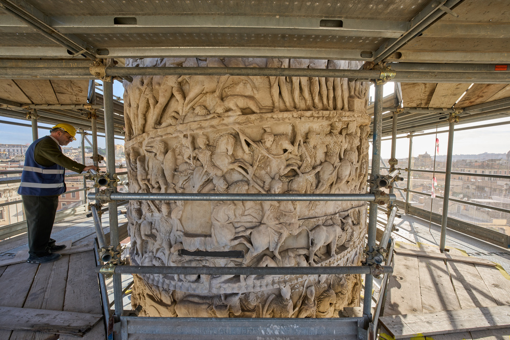 Luca Del Fra, press officer for Rome's Special Superintendency looks at bas-reliefs depicting scenes from a battle on the second-century A.D. Column of Marcus Aurelius in central Rome during a media tour, Thursday, Dec. 18, 2025. (AP Photo/Domenico Stinellis)