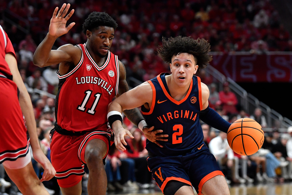 Virginia guard Chance Mallory (2) drives against Louisville guard Kobe Rodgers (11) during the first half of an NCAA college basketball game in Louisville, Ky., Tuesday, Jan. 13, 2026. (AP Photo/Timothy D. Easley)