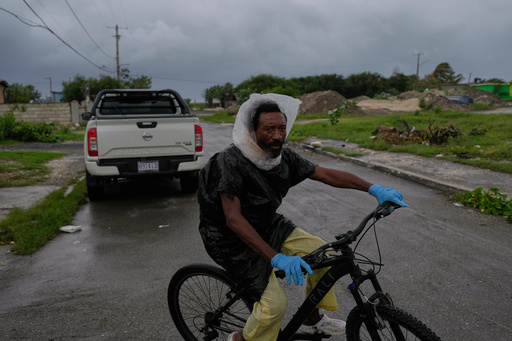 A man rides a bicycle ahead of the forecast arrival of Hurricane Melissa in Kingston, Jamaica, Sunday, Oct. 26, 2025. (AP Photo/Matias Delacroix) A man rides a bicycle ahead of the forecast arrival of Hurricane Melissa in Kingston, Jamaica, Sunday, Oct. 26, 2025. (AP Photo/Matias Delacroix)