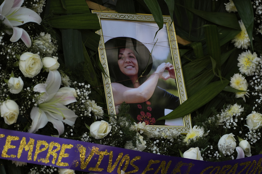 FILE - A framed image of Ximena Guzmán, the personal secretary to Mexico City Mayor Clara Brugada who was murdered a day earlier, adorns an altar during a wake at a funeral home in Mexico City, May 21, 2025. (AP Photo/Marco Ugarte, File)