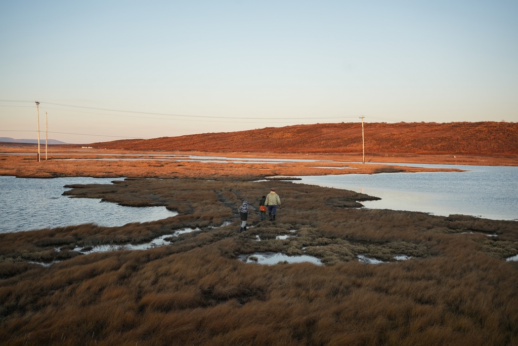 FILE - Roswell Schaeffer, an Inupiaq hunter and fisher, takes his great-grandson James Schaeffer, 7, and James' cousin Charles Gallahorn, 10, hunting in Kotzebue, Alaska, Sept. 26, 2025. (AP Photo/Annika Hammerschlag, File)
