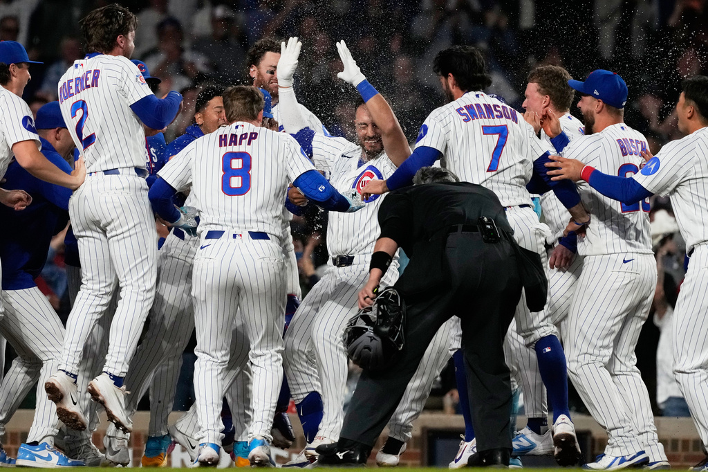 Chicago Cubs' Michael Conforto, center, celebrates with teammates after hitting the winning solo home run during the ninth inning of a baseball game against the Cincinnati Reds in Chicago, Monday, May 4, 2026. (AP Photo/Nam Y. Huh)