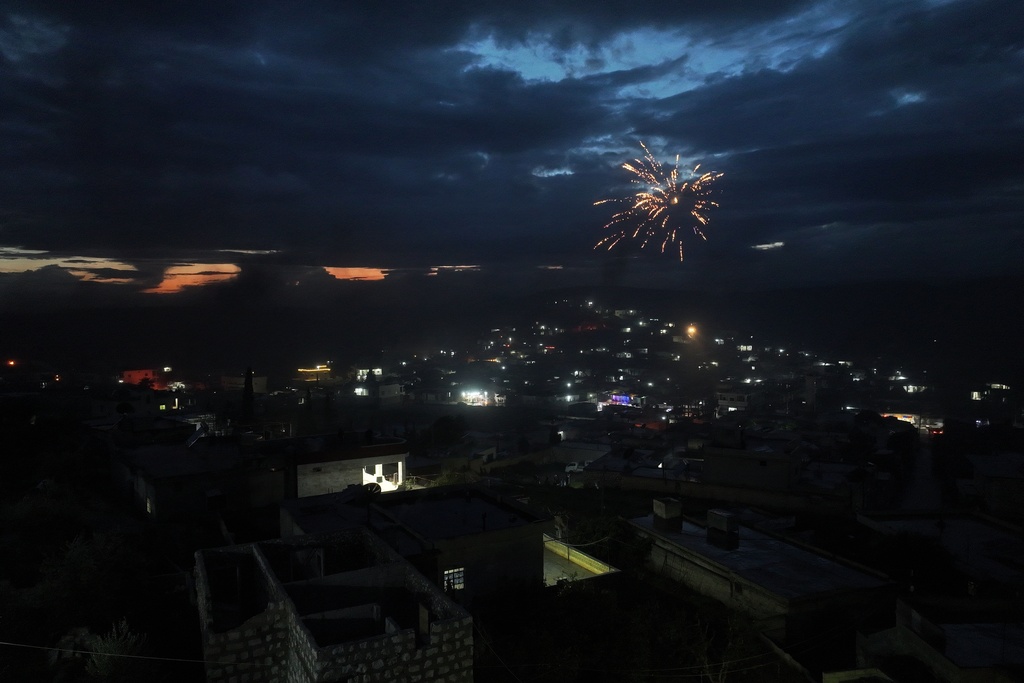 Fireworks illuminate the sky as Syrian Kurds celebrate Nowruz, the Persian New Year, in the village of Basuta in the Afrin countryside, Syria, Friday, March 20, 2026. (AP Photo/Ghaith Alsayed)