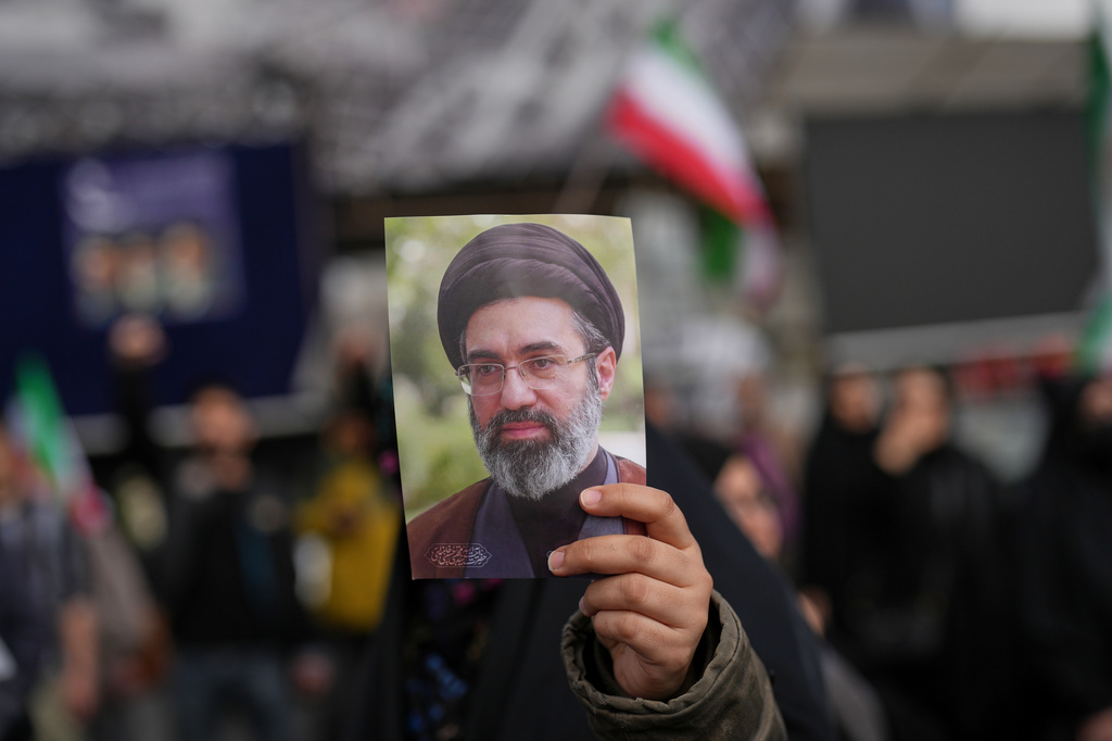 A demonstrator holds a picture of Iran's Supreme Leader Mojtaba Khamenei during a gathering after announcement of a two-week ceasefire with the United States and Israel, in Tehran, Iran, Wednesday, April 8, 2026. (AP Photo/Francisco Seco)
