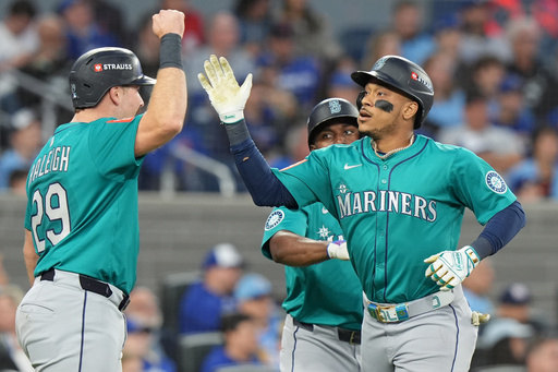 Seattle Mariners' Jorge Polanco, right, celebrates after his a three-run home run with Cal Raleigh (29) during the fifth inning of Game 2 of baseball's American League Division Series against the Toronto Blue Jays in Toronto, Monday, Oct. 13, 2025. (Frank Gunn/The Canadian Press via AP) Seattle Mariners' Jorge Polanco, right, celebrates after his a three-run home run with Cal Raleigh (29) during the fifth inning of Game 2 of baseball's American League Division Series against the Toronto Blue Jays in Toronto, Monday, Oct. 13, 2025. (Frank Gunn/The Canadian Press via AP)