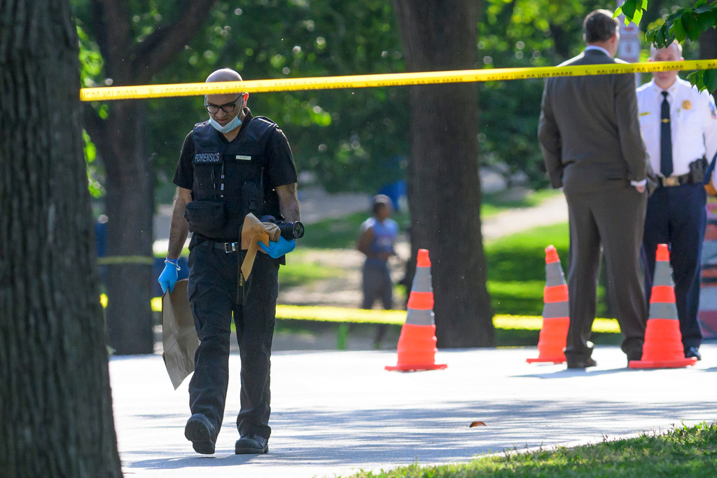 A member of the forensics team walks near the scene after a person was shot by law enforcement near the Washington Monument in Washington, Monday, May 4,, 2026. (AP Photo/Rod Lamkey Jr.)