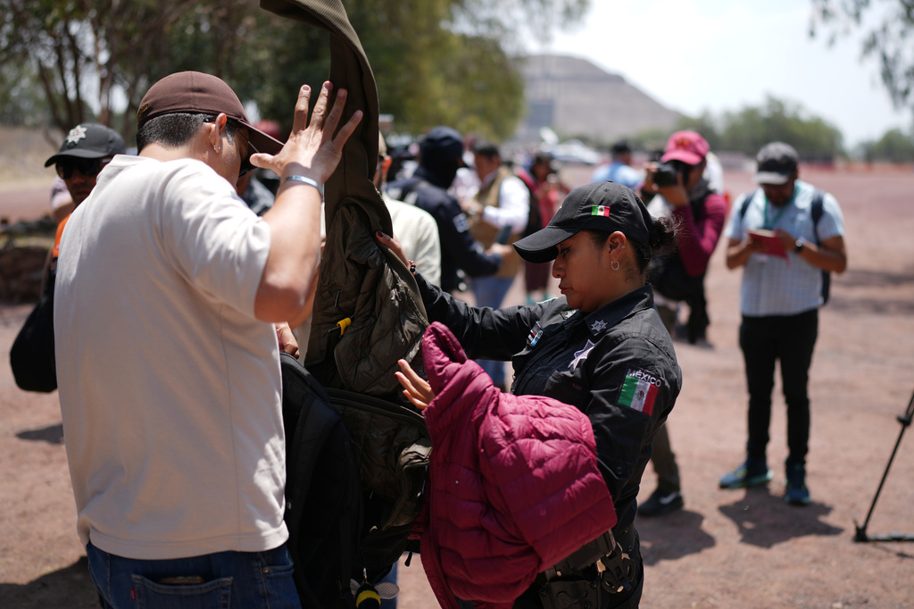 Police frisk visitors as the Teotihuacan pyramids reopen two days after a gunman opened fire at the archaeological site on the outskirts of Mexico City, Wednesday, April 22, 2026. (AP Photo/Eduardo Verdugo)