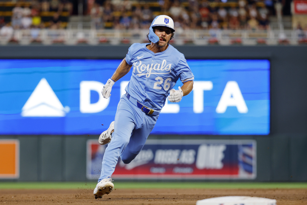 Kansas City Royals' Adam Frazier rounds third base en route to scoring against the Minnesota Twins on a Jonathan India single in the ninth inning of a baseball game Saturday, Aug. 9, 2025, in Minneapolis. (AP Photo/Bruce Kluckhohn)