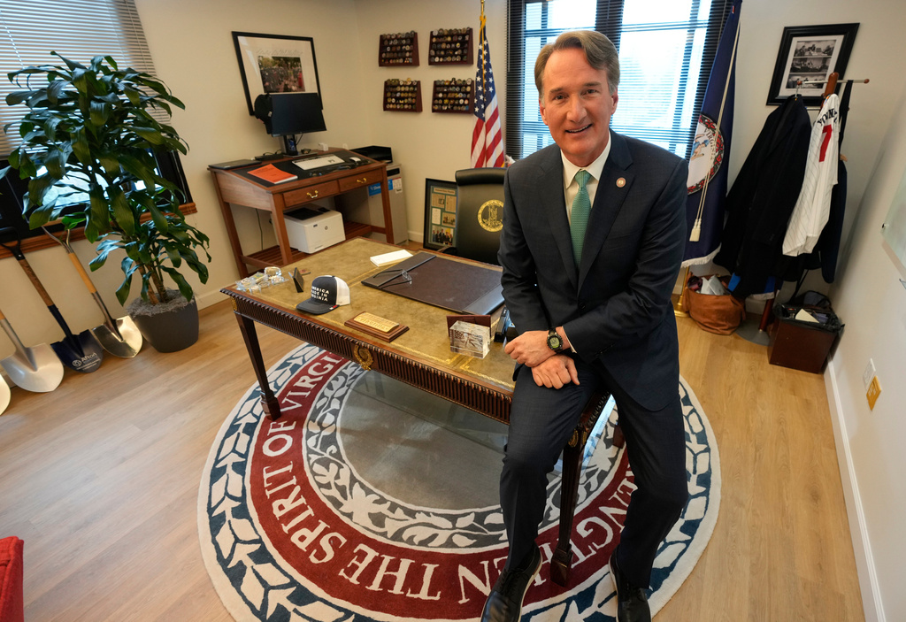 Virginia Gov. Glenn Youngkin gestures during an interview in his office at the Capitol Wednesday Dec. 10, 2025, in Richmond, Va. (AP Photo/Steve Helber)