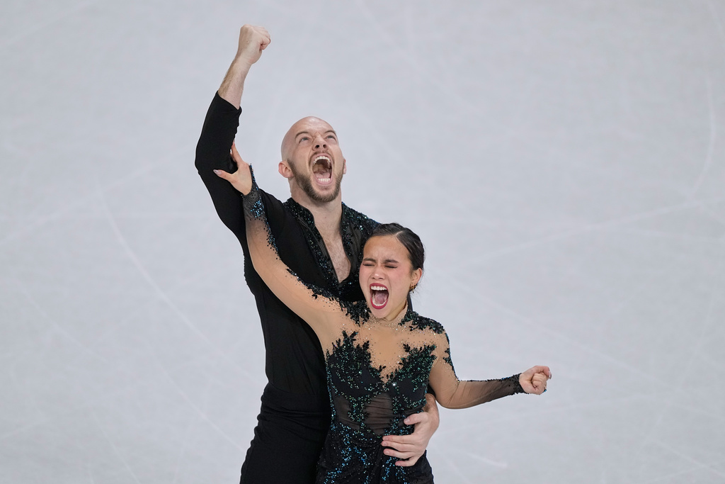 Ellie Kam and Danny O'Shea of the United States compete during the figure skating pairs team event at the 2026 Winter Olympics, in Milan, Italy, Sunday, Feb. 8, 2026. (AP Photo/Natacha Pisarenko)