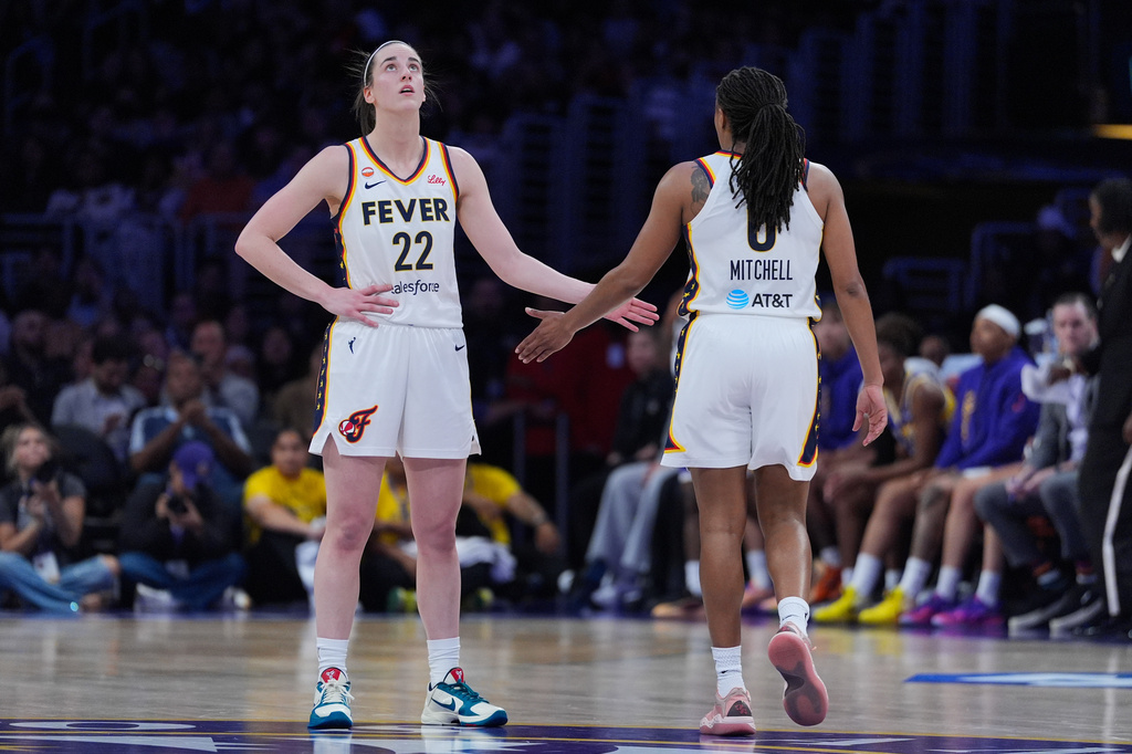 Indiana Fever guard Caitlin Clark (22) and guard Kelsey Mitchell (0) react to a play during the first half of a WNBA basketball game against the Los Angeles Sparks Wednesday, May 13, 2026, in Los Angeles. (AP Photo/Jae C. Hong)