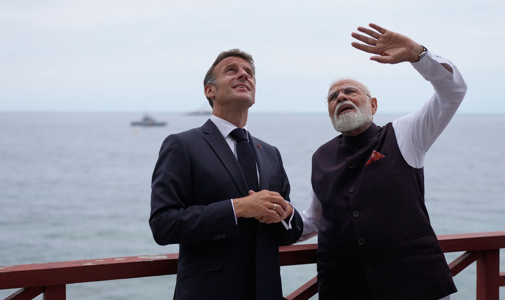 French President Emmanuel Macron, left, listens to Indian Prime Minister Narendra Modi, as they arrive for bilateral talks in Beaulieu-sur-Mer, southern France, on Sunday, June 14, 2026. (AP Photo/Lewis Joly, Pool)