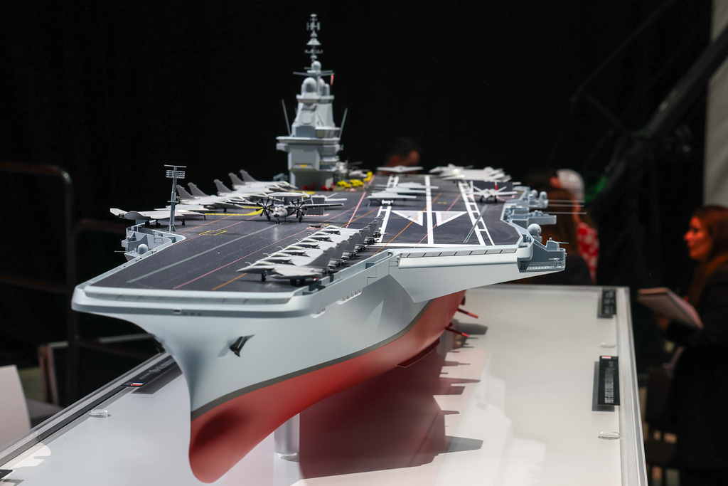 The model of the ship named "France Libre" is displayed, as French President Emmanuel Macron visits the construction site of Naval Group Nantes-Indret, where the next generation of French aircraft carrier is under construction, in Indret, France, Wednesday, March 18, 2026. (Gonzalo Fuentes/Pool Photo via AP)