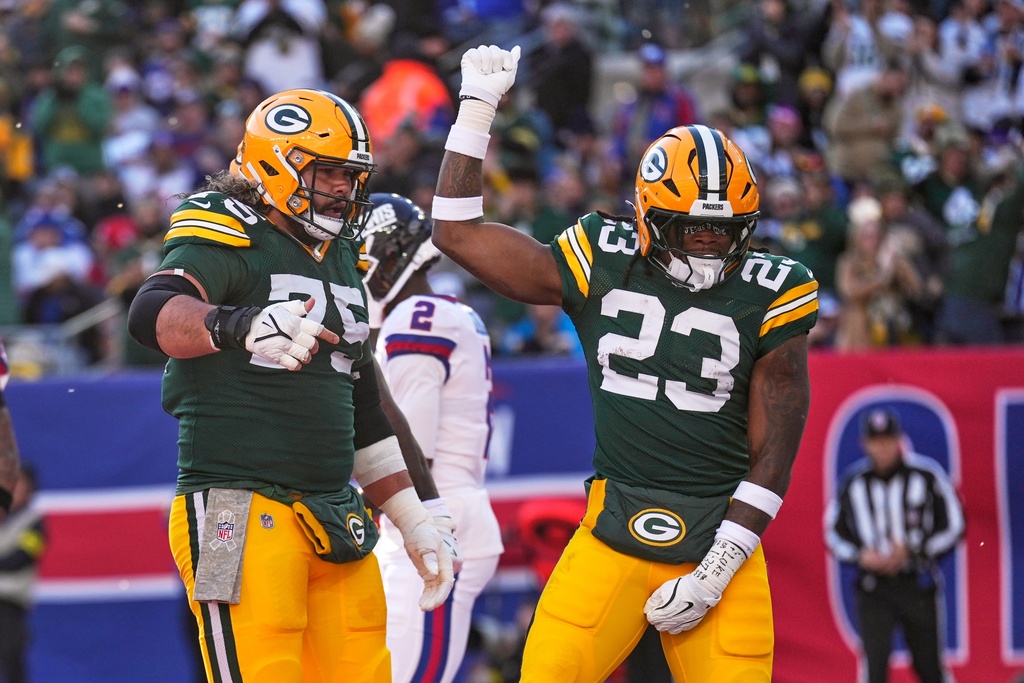Green Bay Packers' Emanuel Wilson celebrates his touchdown run with Sean Rhyan during the first half of an NFL football game against the New York Giants Sunday, Nov. 16, 2025, in East Rutherford, N.J. (AP Photo/Seth Wenig)