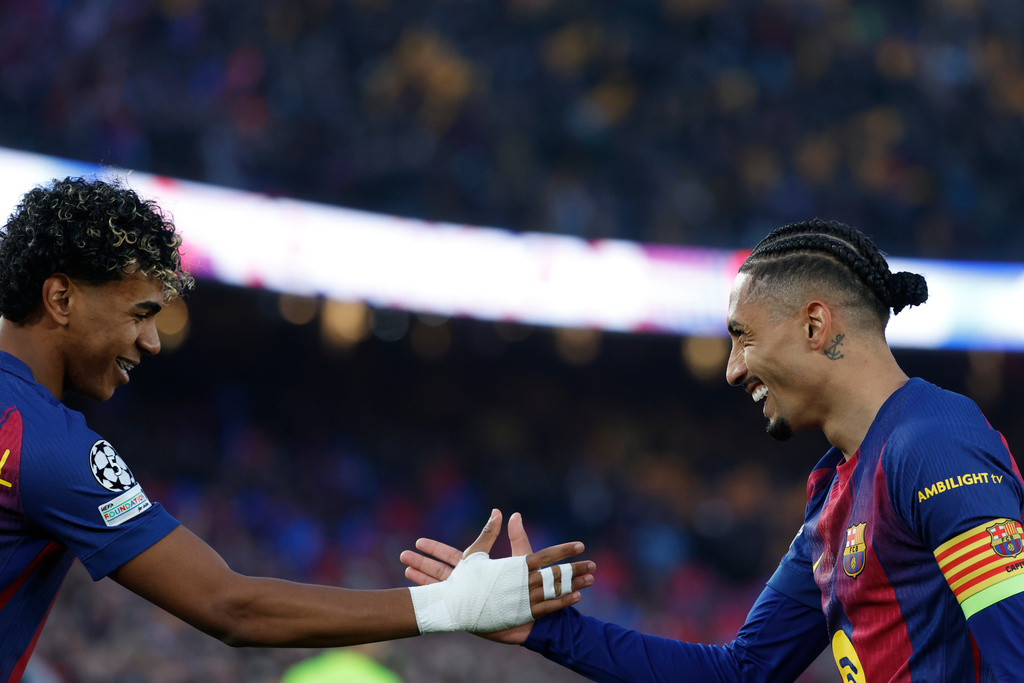 Barcelona's Raphinha, right, celebrates with teammate Lamine Yamal after scoring the opening goal of his team during the Champions League round of 16, second leg soccer match between FC Barcelona and Newcastle United FC in Barcelona, Spain, Wednesday, March 18, 2026. (AP Photo/Joan Monfort)