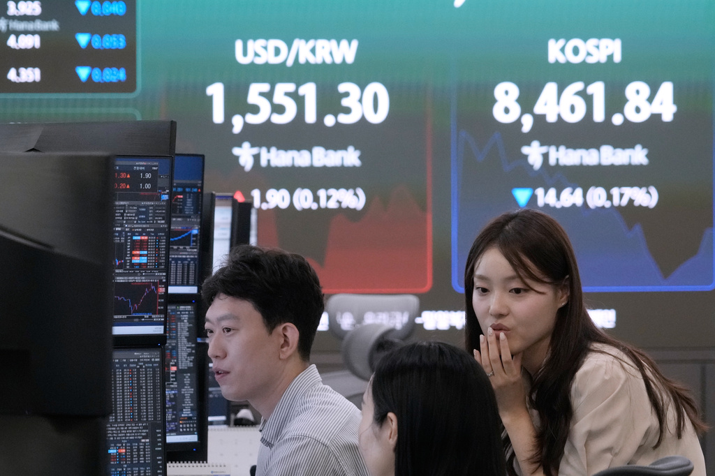 Currency traders work near a screen showing the Korea Composite Stock Price Index (KOSPI) and the foreign exchange rate between U.S. dollar and South Korean won at the foreign exchange dealing room of the Hana Bank headquarters in Seoul, South Korea, Wednesday, July 1, 2026. (AP Photo/Ahn Young-joon)