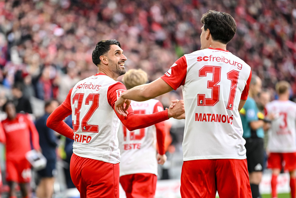 SC Freiburg's Vincenzo Grifo celebrates scoring a goal with teammate Igor Matanović, during a German Bundesliga soccer match between SC Freiburg and Eintracht Frankfurt, in Freiburg im Breisgau, Germany, Sunday, Oct. 19, 2025. (Harry Langer/dpa via AP)