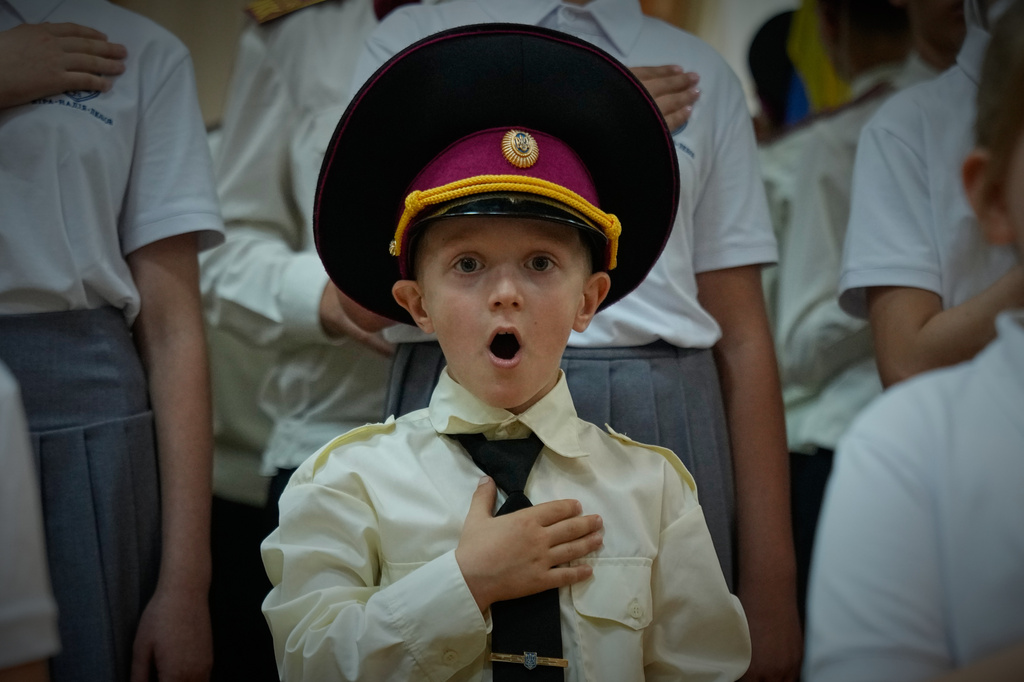 Cadets sing the national anthem on the first day at school in a cadet lyceum in Kyiv, Ukraine, Tuesday, Sept. 1, 2026. (AP Photo/Efrem Lukatsky)