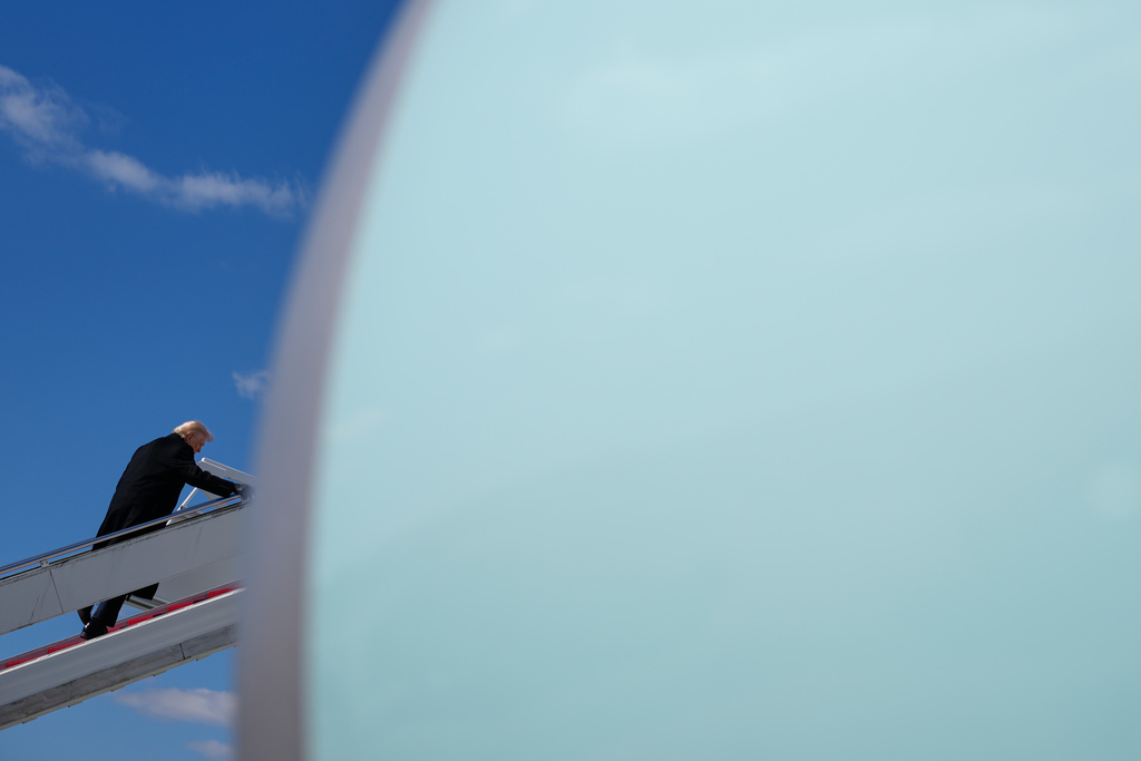 President Donald Trump boards Air Force One, Wednesday, March 18, 2026, at Dover Air Force Base, Del., after attending the casualty return for the six crew members of an Air Force refueling aircraft who died when their plane crashed in western Iraq while supporting operations against Iran. (AP Photo/Julia Demaree Nikhinson)