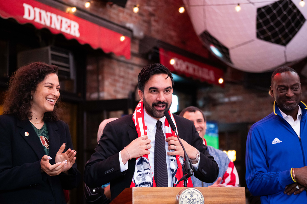 New York Mayor Zohran Mamdani wears a Thierry Henry scarf as he makes a World Cup soccer tournament announcement at Harlem Tavern, Thursday, May 21, 2026, in New York. (AP Photo/Adam Gray)