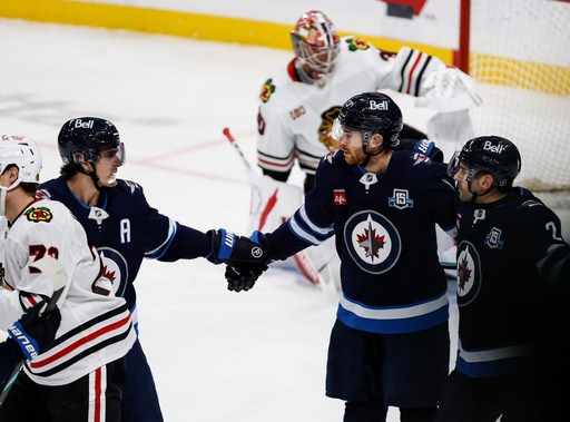 Winnipeg Jets' Mark Scheifele, second from left, and Dylan DeMelo (2) celebrate after a goal by Gabriel Vilardi (13) against the Chicago Blackhawks during second-period NHL hockey game action in Winnipeg, Manitoba, Thursday, Oct. 30, 2025. (John Woods/The Canadian Press via AP) Winnipeg Jets' Mark Scheifele, second from left, and Dylan DeMelo (2) celebrate after a goal by Gabriel Vilardi (13) against the Chicago Blackhawks during second-period NHL hockey game action in Winnipeg, Manitoba, Thursday, Oct. 30, 2025. (John Woods/The Canadian Press via AP)