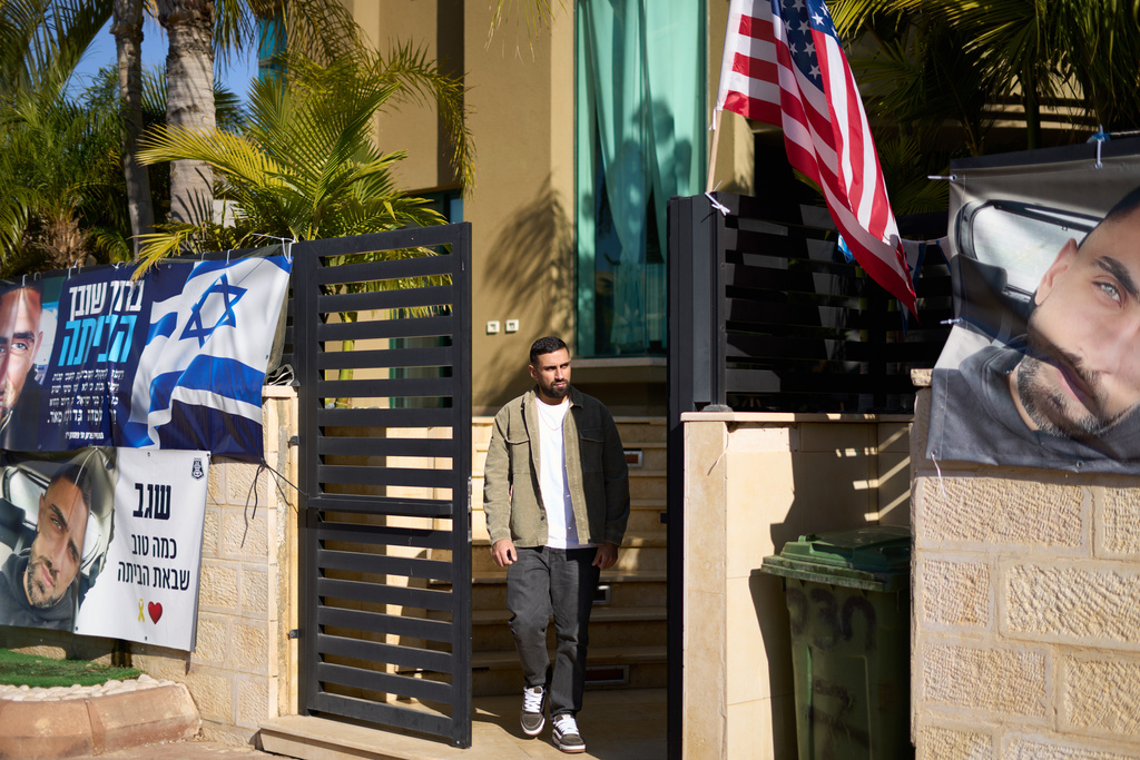 Segev Kalfon, an Israeli hostage who spent two years in captivity in a Hamas tunnel and was released from the Gaza Strip in a ceasefire deal on Oct. 13, steps out of his home in Dimona, southern Israel, Tuesday, Dec. 23, 2025. (AP Photo/Ariel Schalit)