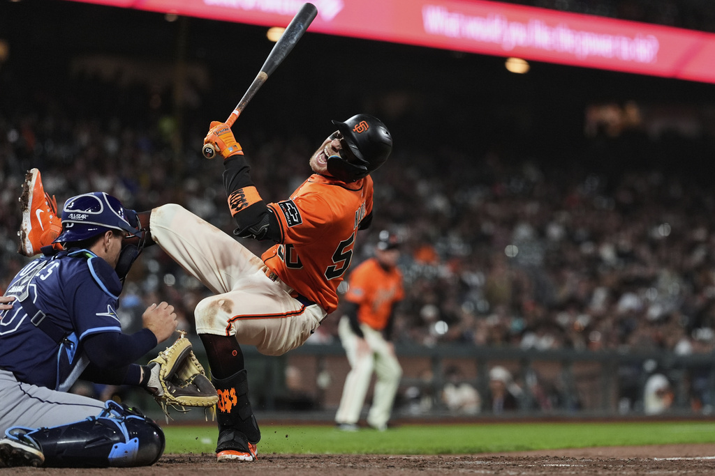 San Francisco Giants' Christian Koss, right, reacts next to Tampa Bay Rays catcher Nick Fortes after being hit by a pitch during the eighth inning of a baseball game Friday, Aug. 15, 2025, in San Francisco. (AP Photo/Godofredo A. Vásquez)
