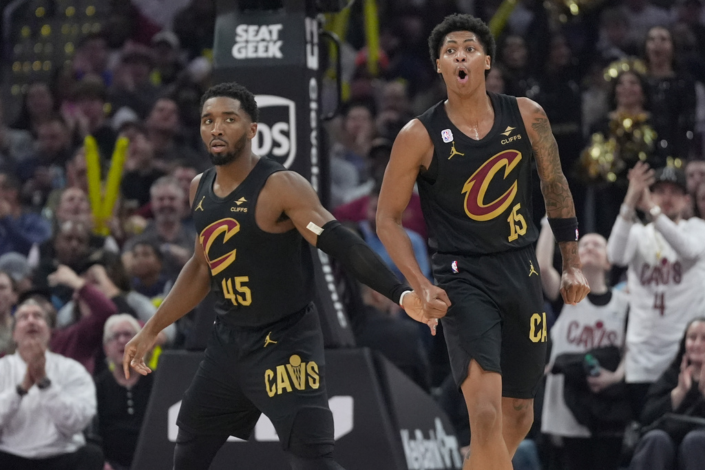 Cleveland Cavaliers guard Meleek Thomas, right, celebrates a three-point basket next to guard Donovan Mitchell (45) in the second half of an NBA basketball game against the Minnesota Timberwolves, Monday, Oct. 26, 2026, in Cleveland. (AP Photo/Sue Ogrocki.
