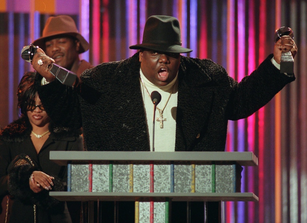 FILE - In this Dec. 6, 1995, file photo, The Notorious B.I.G., who won rap artist and rap single of the year, clutches his awards at the podium during the annual Billboard Music Awards in New York. (AP Photo/Mark Lennihan, File)