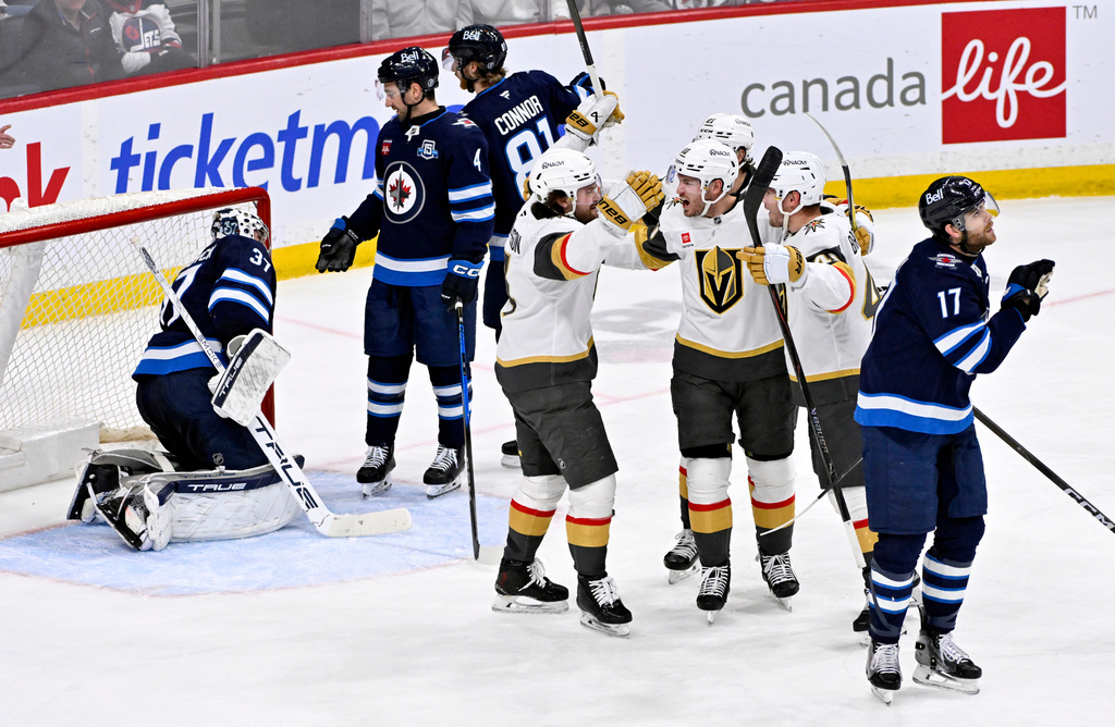 Vegas Golden Knights' Colton Sissons (10) celebrates his goal on the Winnipeg Jets with Rasmus Andersson (4) and Ivan Barbashev (49) during the second period of their NHL hockey game in Winnipeg, Tuesday, March 24, 2026. (Fred Greenslade/The Canadian Press via AP)