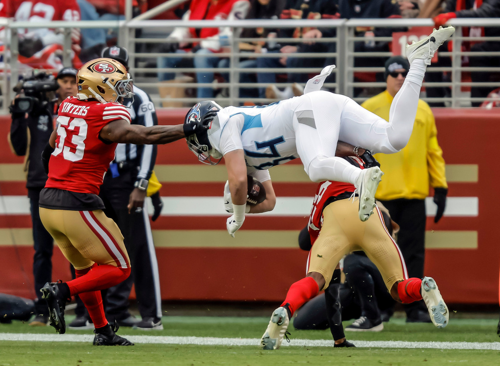 Tennessee Titans tight end Gunnar Helm is upended by San Francisco 49ers cornerback Jason Pinnock in the first half of an NFL football game in Santa Clara, Calif., Sunday, Dec. 14, 2025. (Carlos Avila Gonzalez/San Francisco Chronicle via AP)