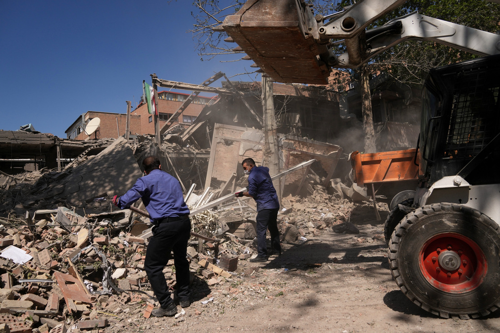 Workers remove debris at Tehran's Sharif University of Technology complex that Iranian authorities say was hit early Monday by a U.S.-Israeli strike, in Tehran, Iran, Monday, April 6, 2026. (AP Photo/Francisco Seco)