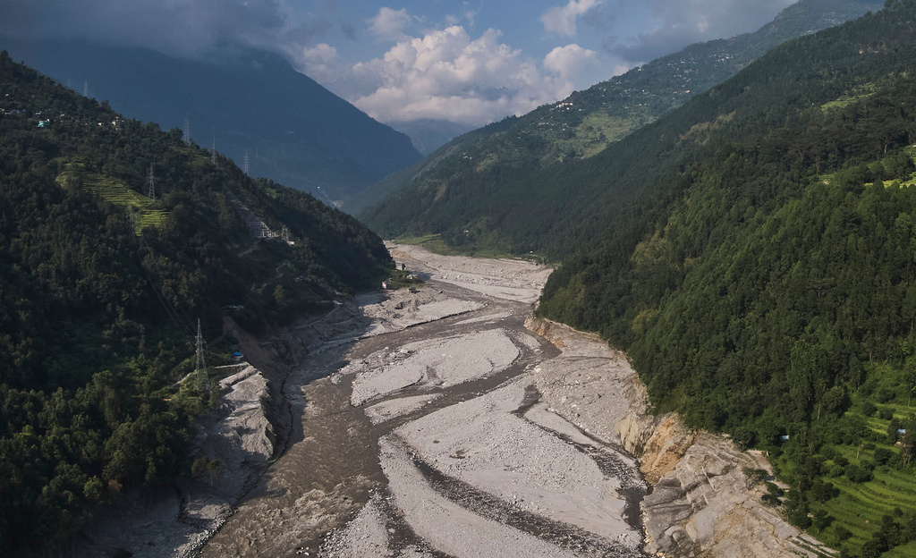 An aerial view shows the area where Khalte and other villages stood before being devastated by the flash floods in August, in Nepal's Rasuwa district, Oct. 2, 2026. (AP Photo/Niranjan Shrestha)