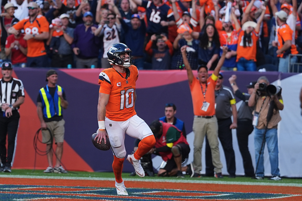 Denver Broncos quarterback Bo Nix (10) celebrates after scoring against the New York Giants during the second half of an NFL football game in Denver, Sunday, Oct. 19, 2025. (AP Photo/David Zalubowski)