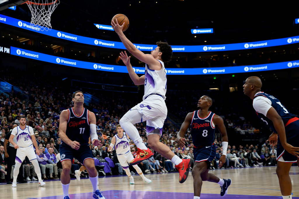 Utah Jazz guard Walter Clayton Jr. (13) goes to the basket for a lay up during the first half of an NBA basketball game, Wednesday, Oct. 22, 2025, in Salt Lake City. (AP Photo/Tyler Tate)