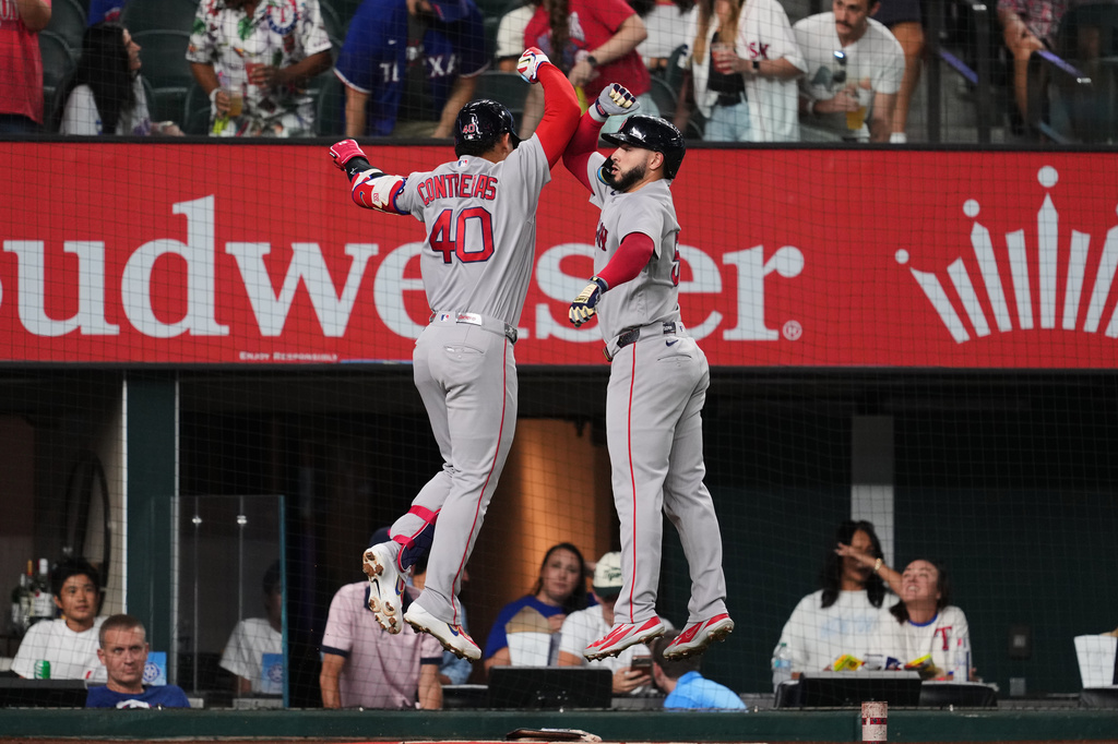 Boston Red Sox's Willson Contreras (40) and Wilyer Abreu, right, celebrate Contreras two-run home run in the first inning of a baseball game against the Texas Rangers Wednesday, Sept. 16, 2026, in Arlington, Texas. (AP Photo/Tony Gutierrez)