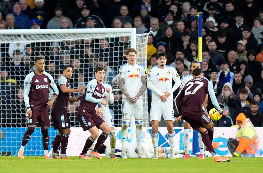 Aston Villa's Morgan Rogers scores their side's second goal of the game during the Premier League match between Leeds and Aston Villa in Leeds, England, Sunday, Nov. 23, 2025. (Danny Lawson/PA via AP)