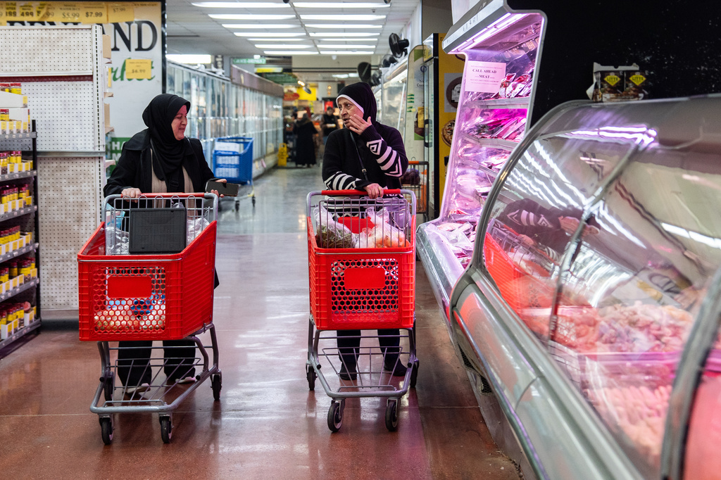 Women talk while shopping for meat at Super Greenland Market, a Mediterranean grocery story, Wednesday, April 8, 2026, in Dearborn, Mich. (AP Photo/Julia Demaree Nikhinson)