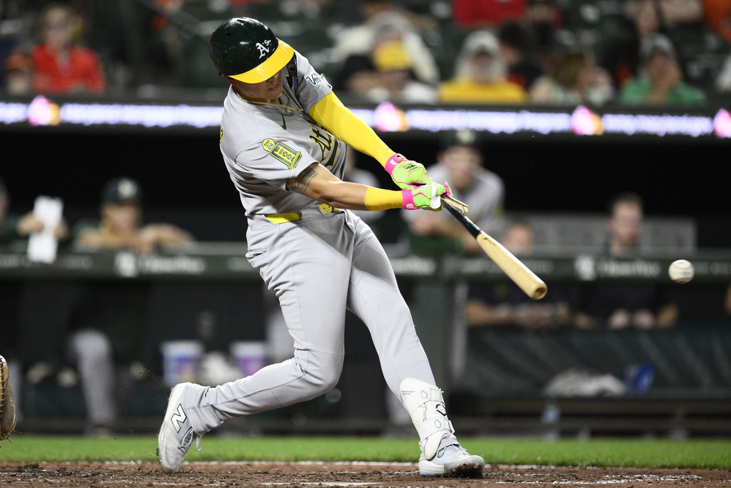Athletics' Gio Urshela breaks his bat as he lines out during the seventh inning of a baseball game against the Baltimore Orioles, Saturday, Aug. 9, 2025, in Baltimore. (AP Photo/Nick Wass)